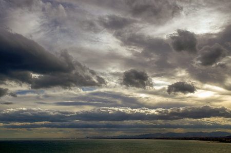 Stormy clouds over the sea. View from the shore.の写真素材