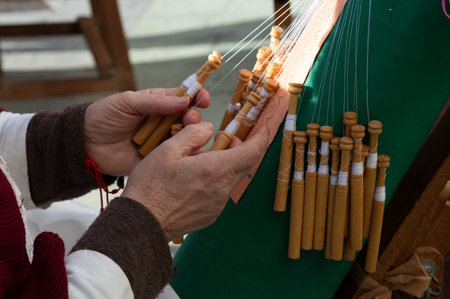 close-up of the hands of an elderly woman knitting with bobbin lace.の写真素材