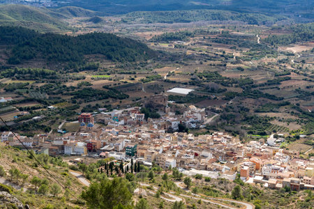 aerial image of a small village surrounded by mountains and natureの写真素材