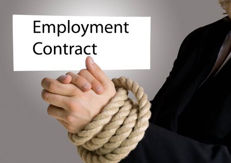 businesswoman with hands in chain hold a banner on which is written employment contractの写真素材