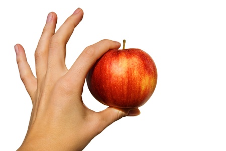 a young hand holds a red apple on whiteの写真素材