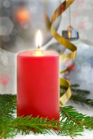 one red single shining candle as dark christmas or advent seasonal backgroundの写真素材
