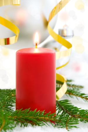 one single red candle shining; advent and christmas seasonal backgroundの写真素材