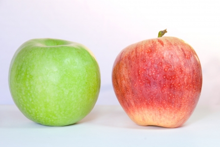 one green and one red apple, on whiteの写真素材
