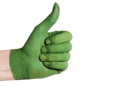 a green painted hand shows one thumb up symbolizing something good till exempel environment and natureの写真素材