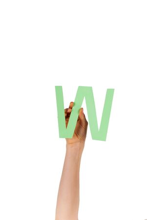 the letter W, hold by a hand, isolatedの写真素材