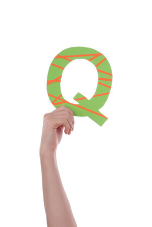 A Hand Holding a Colorful Q, Isolatedの写真素材