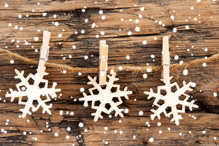 Snowflakes on a Line with Snow on it all overの写真素材