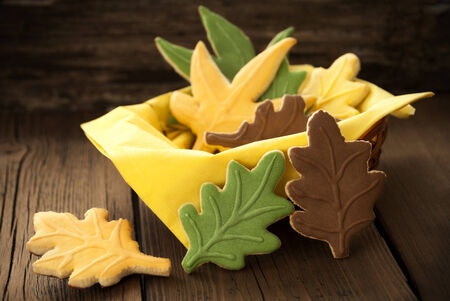 Fall Cookies in different Autumnal Colors in a Cup on Woodの写真素材