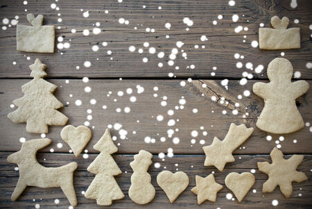 Ginger Bread Cookies as a Frame on Wood with Snow and Copy Space, Christmas or Winter Background with Free Spaceの写真素材