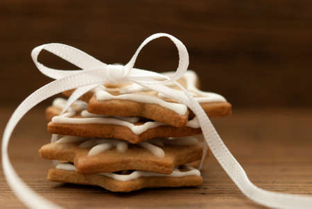 Ginger Bread Cookies with white Ribbon and Bow on Wood with Copy Spaceの写真素材