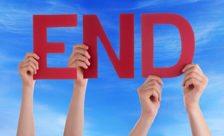 Many Caucasian People And Hands Holding Red Straight Letters Or Characters Building The English Word End On Blue Skyの写真素材
