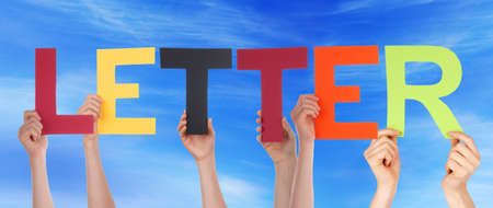 Many Caucasian People And Hands Holding Colorful Straight Letters Or Characters Building The English Word Letter On Blue Skyの写真素材