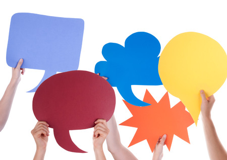 Many Hands Holding Colorful Speech Balloons Or Speech Bubbles With Copy Space Isolated On Whiteの写真素材
