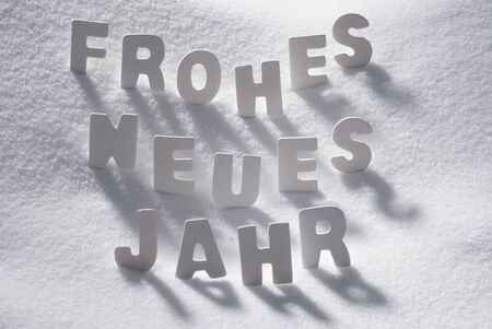 White Wooden Letters Building GermanText Frohes Neues Jahr Means Happy New Year. Snow And Snowy Scenery. Christmas Atmosphere. Christmas Background Or Christmas Card For Seasons Greetingsの写真素材