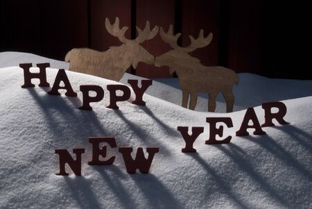 Red Letters On White Snow As Christmas Card.  English Text Or Word Happy New Year. Moose Couple In...