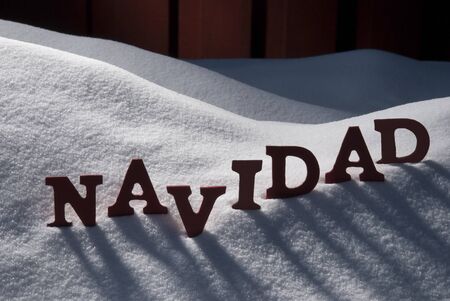 Red Letters On White Snow As Christmas Card.  Spanish Word Navidad Means Christmas. Snowy Scenery And Atmosphere. Rustic Vintage Wooden Backgroundの写真素材