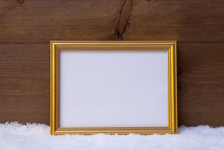 One Golden Retro Picture Frame On Snow. Christmas Card With Copy Space For Advertisement. Rustic,...