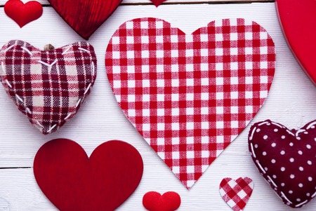 Texture With Many Red Fabric Hearts On White Wooden Background. Romantic Decoration For Valentines Day. Rustic, Retro Or Vintage Style. Copys Space For Advertisement. Close Up Viewの写真素材