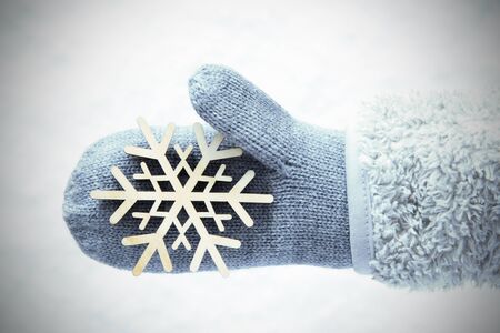 Wool Glove With Wooden Snowflake, Snow Backgroundの写真素材