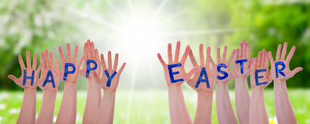 Word Happy Easter On Hands, Sunny Meadowの写真素材