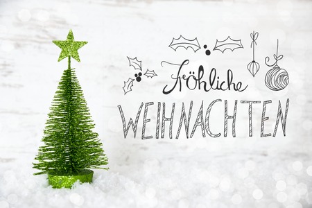 Green Tree, Snow, Calligraphy Froheliche Weihnachten Means Merry Christmasの写真素材