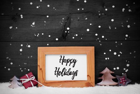 Frame With English Calligraphy Happy Holidays. Christmas Decoration Like Gift, Tree And Star. Gray Wooden Background With Snowflakesの写真素材