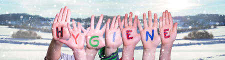 Kids Hands Holding Word Hygiene, Snowy Winter Backgroundの写真素材