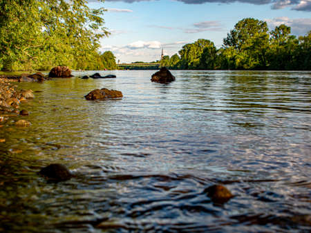 far view over a riverbank with stones