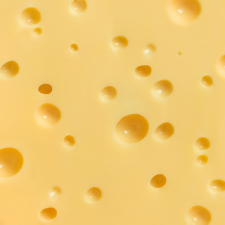 cheese slice texture. yellow backgroundの写真素材