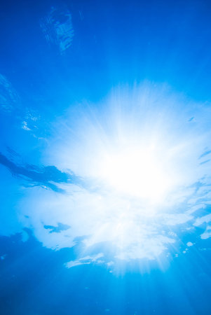 underwater background, deep blue sea with sunraysの写真素材