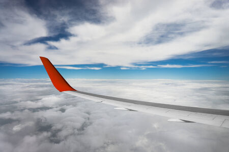 view of airplane wing on blue sky backgroundの写真素材
