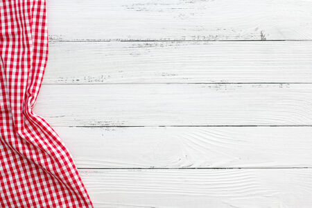 old vintage wooden table with red checked tablecloth and copyspace. still life backgoundの写真素材