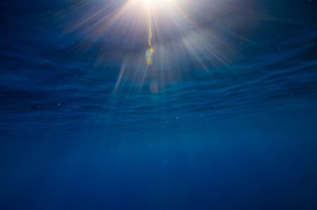 Abstract underwater background with sun raysの写真素材