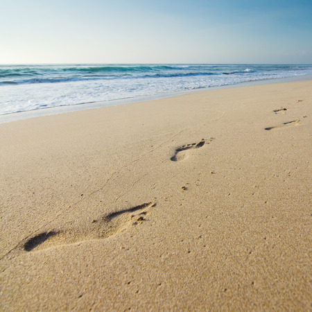 Foot prints on a sandy beachの写真素材