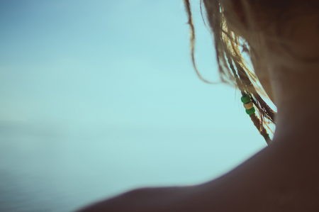 girl looks at the sea. detail close-upの写真素材