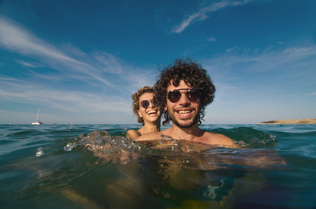 young couple having fun in the seaの写真素材
