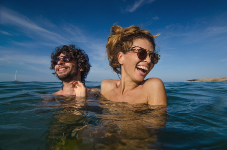 young couple having fun in the seaの写真素材