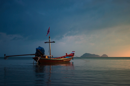 fishing boat at sunset in the tropical seaの写真素材