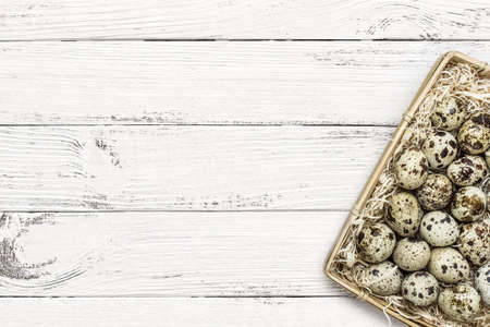 quail eggs on white wooden backgroundの写真素材