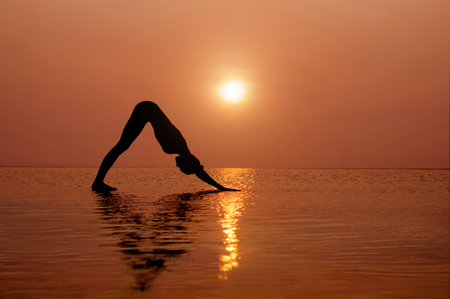 Yoga on the beach at sunset. Different correct asanas set in my portfolioの写真素材