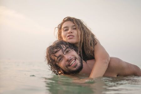 young couple having fun in the sea