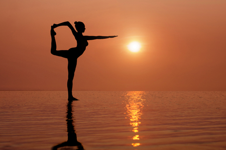Yoga on the beach at sunset. Different correct asanas set in my portfolioの写真素材