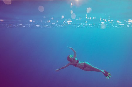 girl dive underwater. soft focus and vintage styleの写真素材