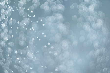 falling snow abstract blue bokeh backgroundの写真素材