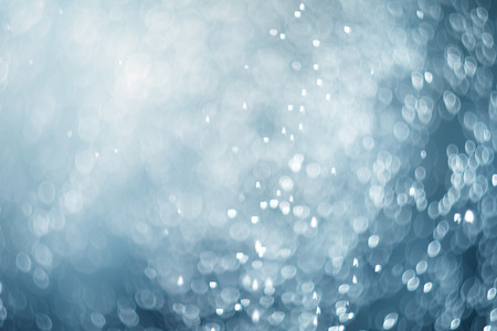 falling snow abstract blue bokeh backgroundの写真素材