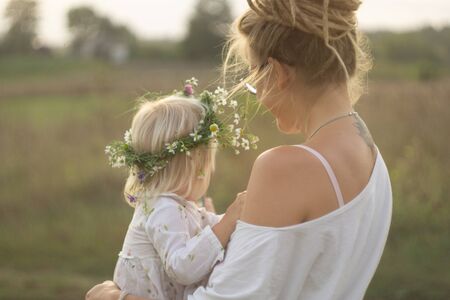 child with mother in the meadowの写真素材