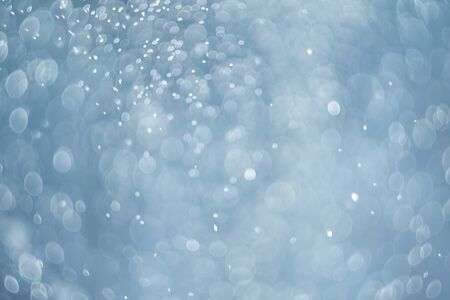 falling snow, abstract blue bokeh backgroundの写真素材