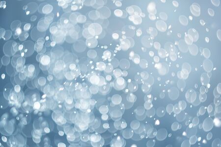 falling snow, abstract blue bokeh backgroundの写真素材