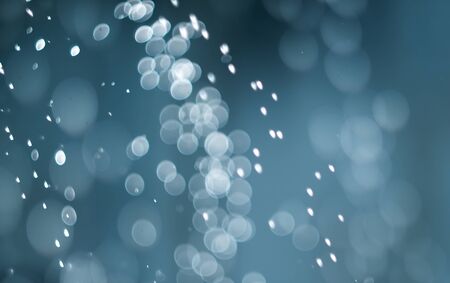 falling snow, abstract blue bokeh backgroundの写真素材